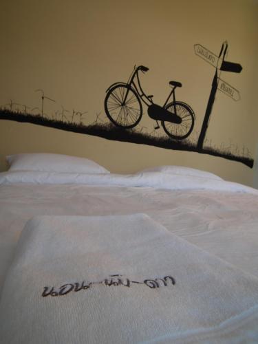 a bed with a bike on top of it at Norn Nab Dao Rimkhong in Chiang Khan