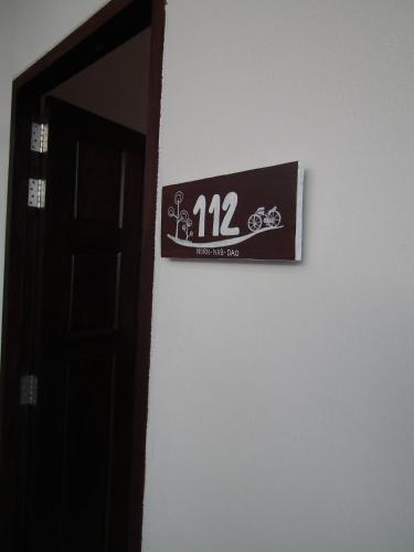 a sign on a wall next to a door at Norn Nab Dao Rimkhong in Chiang Khan