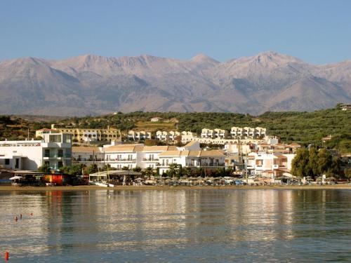 a town on the shore of a body of water at Almyrida Resort in Almirida