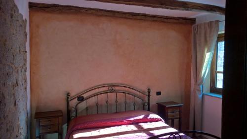 a bedroom with a bed and a window at Fattoria Sos Astores in Fonni