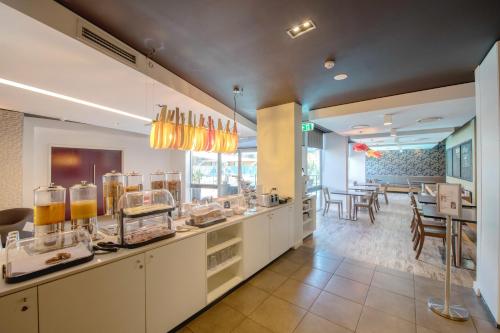 a restaurant with a counter with some food at Royal Pacific Hotel in Sydney