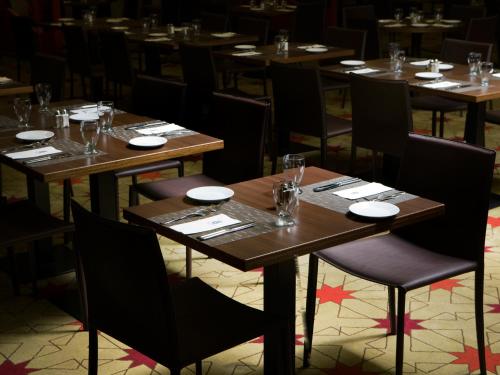 a dining room with wooden tables and chairs at Dan Boutique Hotel Jerusalem in Jerusalem