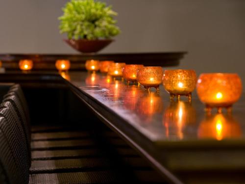a row of candles sitting on top of a piano at Dan Boutique Hotel Jerusalem in Jerusalem