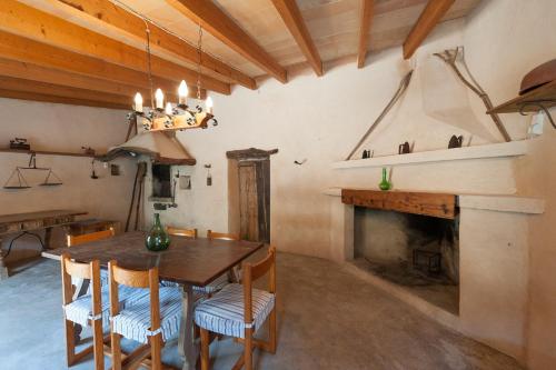 a dining room with a table and a fireplace at Finca Can Maria Costitx in Costitx