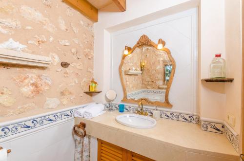 a bathroom with a sink and a mirror at Finca Can Maria Costitx in Costitx