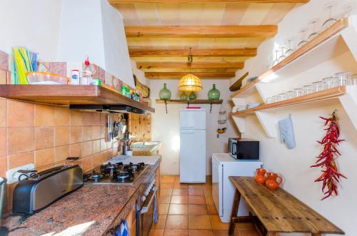 a kitchen with a sink and a stove top oven at Finca Can Maria Costitx in Costitx