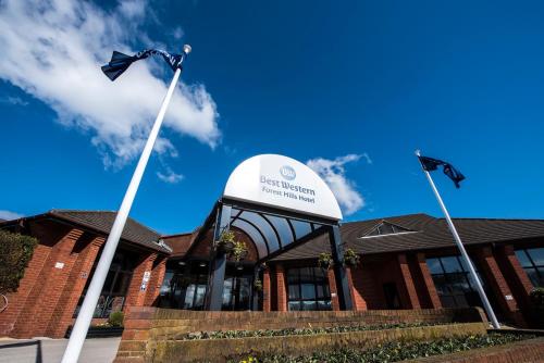a building with a flag pole in front of it at Best Western Frodsham Forest Hills Hotel in Frodsham