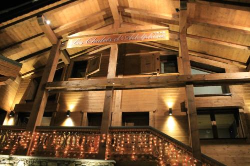 a building with christmas lights and a sign on it at Les Chalets d'Adelphine & SPA in Les Gets