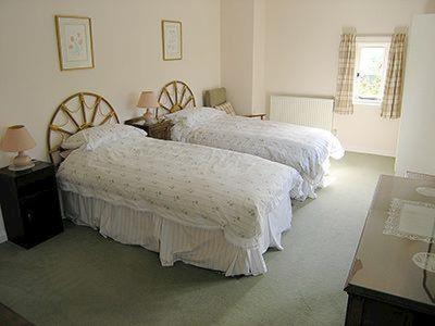 A bed or beds in a room at Howards Cottage 