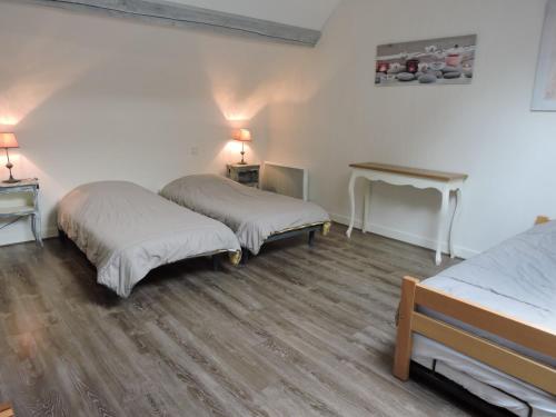a room with two beds and a table in it at Orée des Prairies in Mareuil-sur-Cher