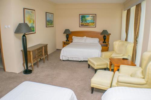 Hotel Feni tesisinde bir odada yatak veya yataklar