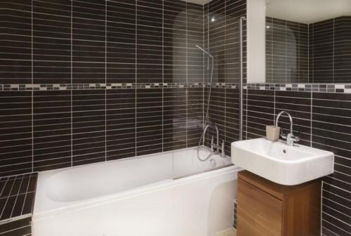 a bathroom with a sink and a bath tub and a bath tub at 16 John Walker House in York