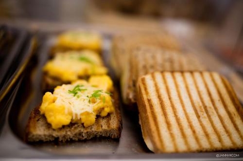three pieces of bread with butter and cheese on it at Hotel U Tří hrušek suites & apartments in České Budějovice