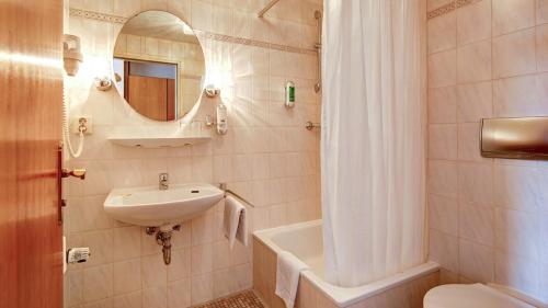 ショルンドルフにあるBTS-Hotelのバスルーム(洗面台、トイレ、鏡付)