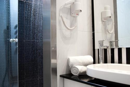 a bathroom with a sink and a shower at Acropolis Museum Boutique Hotel in Athens