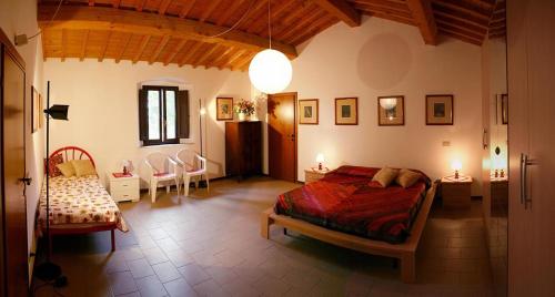 a bedroom with a bed and a table and chairs at Casalevecchio in Casale Marittimo