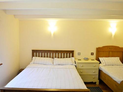 A bed or beds in a room at The Darren Mill Cottage 