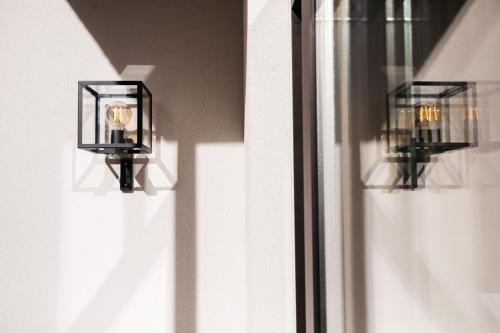 two lights on the side of a window at Charlie's Bed & Breakfast in Antwerp