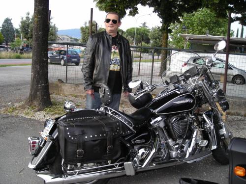 a man is standing next to a motorcycle at Hotel Europa in Perugia