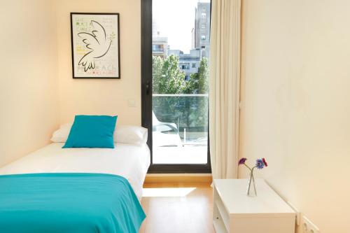 a bedroom with a bed and a window at 1215 - Ciutadella Pretty Apartment in Barcelona