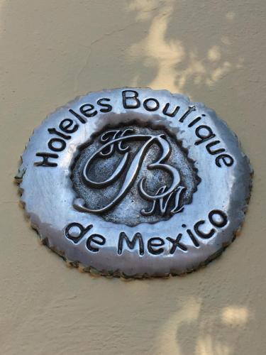 a sign for aissociation of mexico on a wall at Quinta Luna in Cholula
