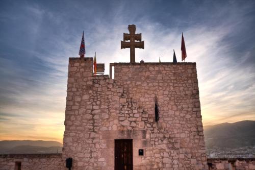 a church with a cross on top of it at Hotel Almunia in Caravaca de la Cruz