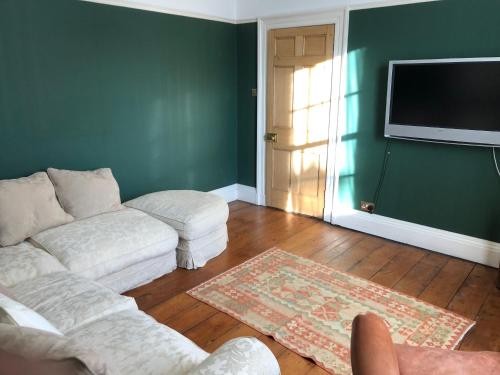 a living room with a couch and a flat screen tv at Seventeen Latham in Preston