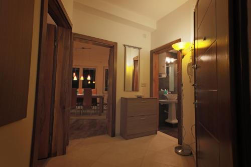 a hallway with a room with a sink and a mirror at Apartments Elena in Ohrid