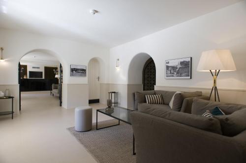 a living room with two couches and a table at Hotel Spa Genovese in Bonifacio