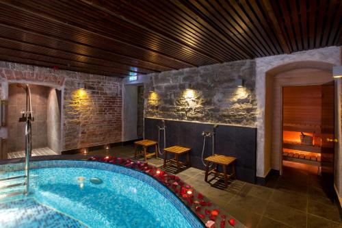 a large swimming pool in a building with a spa at The von Stackelberg Hotel Tallinn in Tallinn