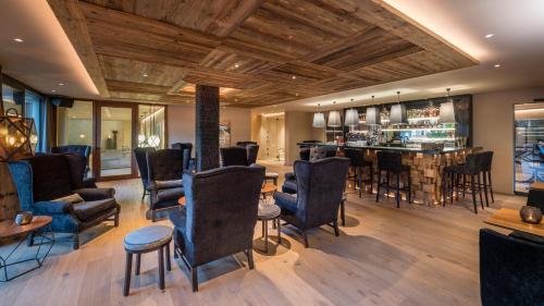 a barber shop with chairs and a barbershop at Hotel Montchalet in Ortisei