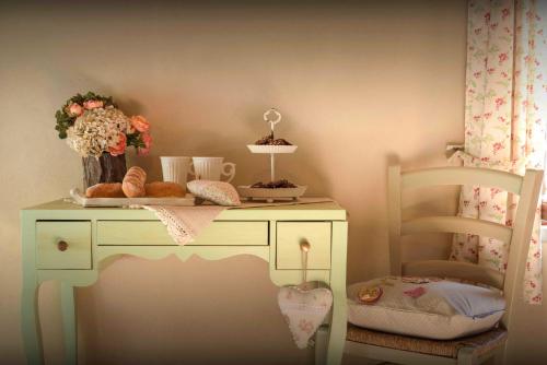 a white desk with a plate of food on it at Casale Talevi in Cartoceto