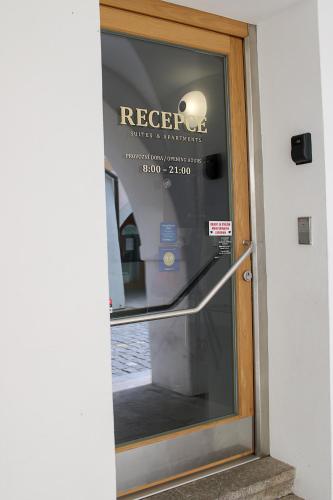 a glass door with a sign on it at Hotel U Tří hrušek suites & apartments in České Budějovice