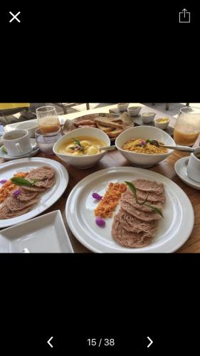 a table with plates of food and bowls of food at The City Tourist Hotel in Anuradhapura