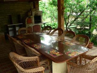 a dining table and chairs with a table and a fireplace at Pension Garofita in Iaşi