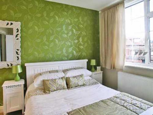 A bed or beds in a room at The Beach Hut 