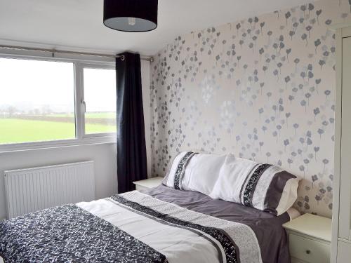 A bed or beds in a room at Royal Oak Meadow 