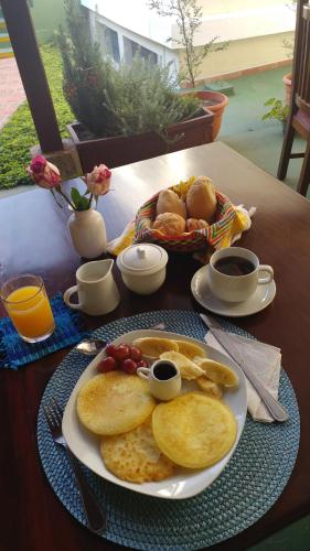 a table with a plate of breakfast food on it at Hostal Donde Regina in Guatemala