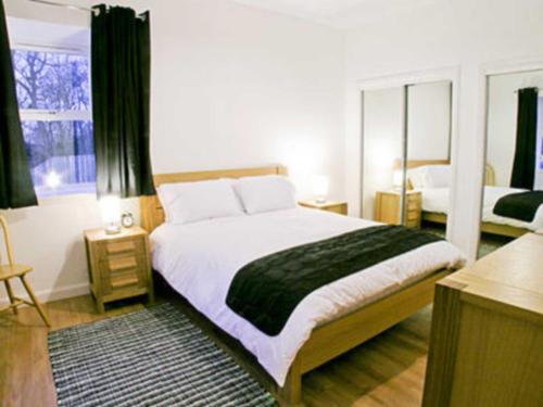 A bed or beds in a room at The Stables 