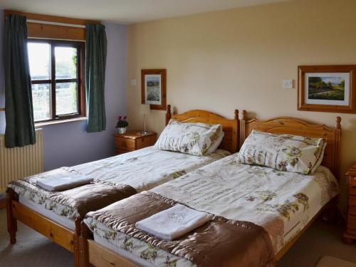 A bed or beds in a room at The Hay Barn 