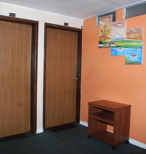 an empty room with two doors and a table at Hotel Bonaventure in Quito