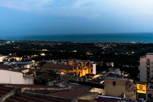 a view of a city at night with the ocean at Casuzza di Girgenti con vista Valle dei Templi! in Agrigento