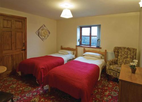 A bed or beds in a room at The Dairy Cottage 