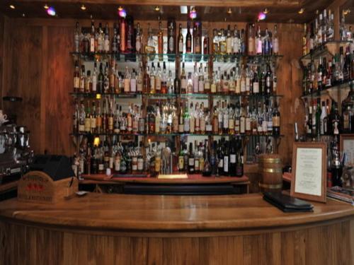 a bar with a lot of bottles of alcohol at Poppies Hotel in Callander