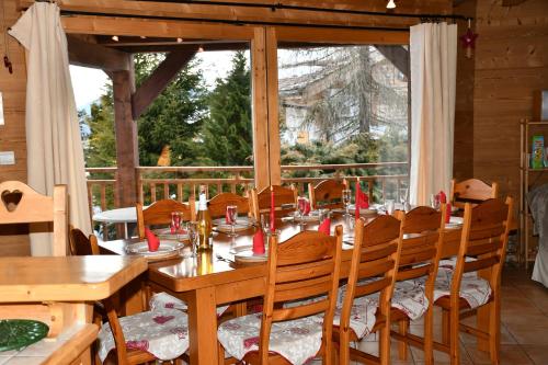 une salle à manger avec une table et des chaises et une fenêtre dans l'établissement Chalet Orlando, aux Gets