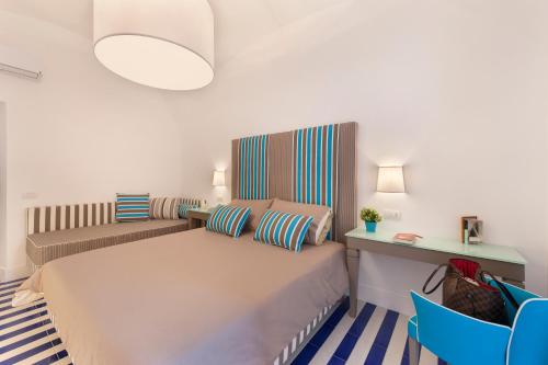 ソレントにあるKira Guest Houseのベッドルーム1室(ベッド1台、青い椅子付)