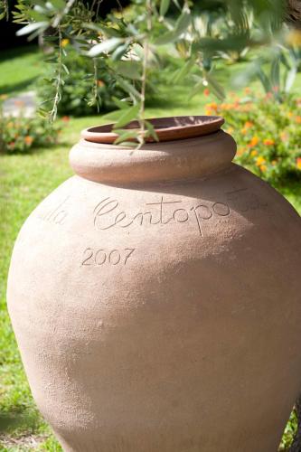 a large stone vase with a plant in it at Tenuta Centoporte in Otranto