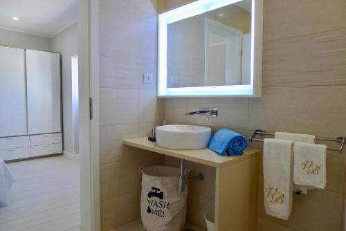 a bathroom with a sink and a mirror at Villa Bellevue 4 in Albufeira
