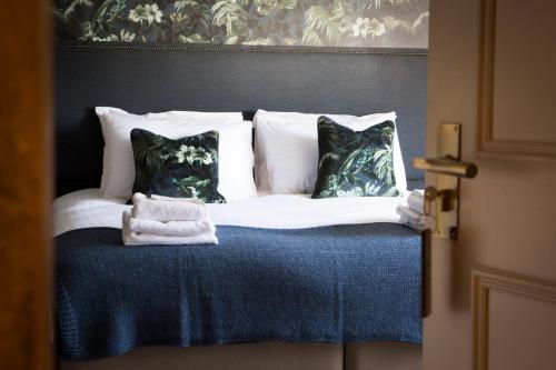 a bedroom with a bed with pillows at Wynnstay Arms, Ruabon, Wrexham in Ruabon