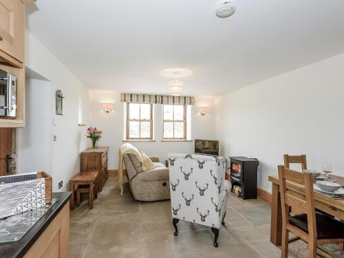 a kitchen and living room with a chair and a table at The Old Hat Factory in Scotforth